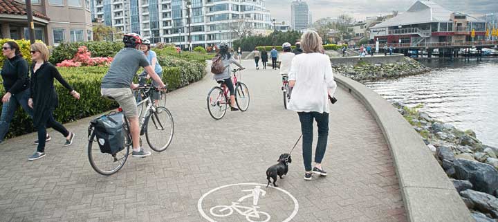 People walking and cycling along seawall along False Creek People walking and cycling along seawall along False Creek