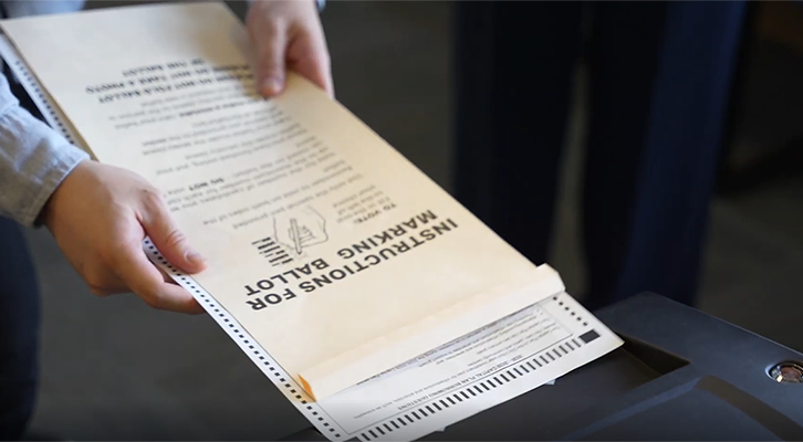 Voting ballot about to go through a tabulator