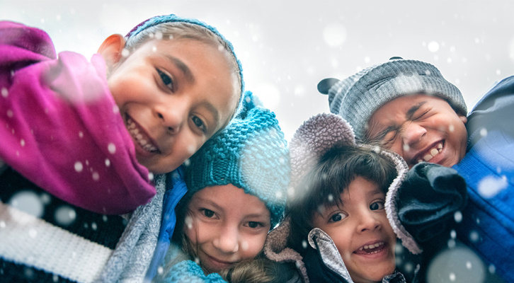 Group of children with snowflakes coming down around them