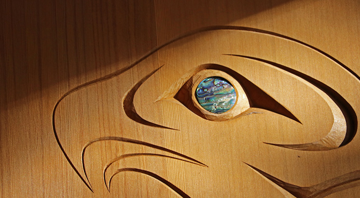 Carved eagle head with abalone shell inlay for the eye