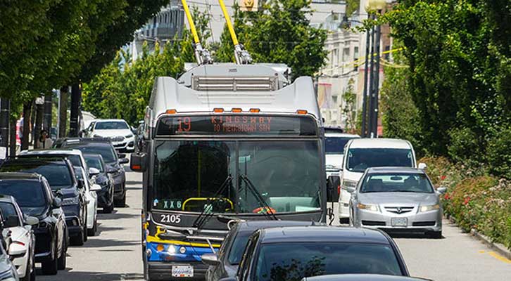 Kingsway bus on a street with cars surrounding it