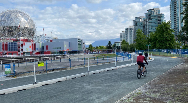 People biking on seawall near Science World