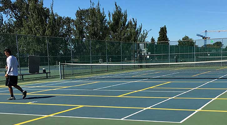 Person walking on a pickleball court