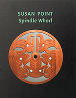 Book cover image of a red, flat circle of wood with Indigenous animal shapes carved into it