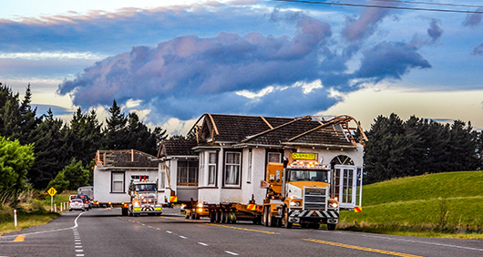 House being relocated on a flatbed truck