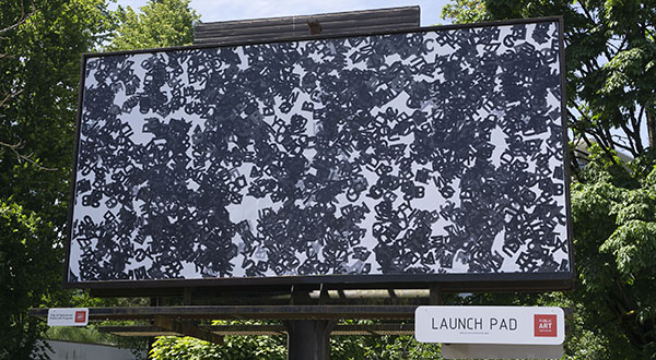	Artist Jazmin Erice's artwork "Onsensenay epeatedray epeatedlyray", letters layered and scattered, on a billboard