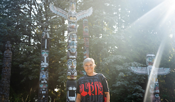 Lou-ann Neel in front of the totem poles at Brockton Point