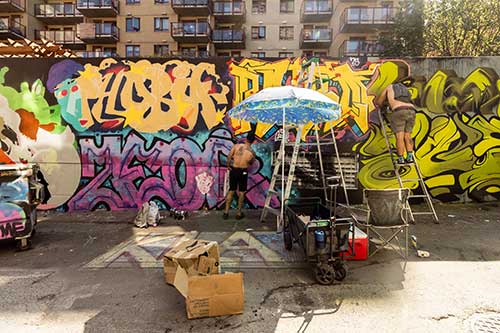 People painting graffiti on the wall