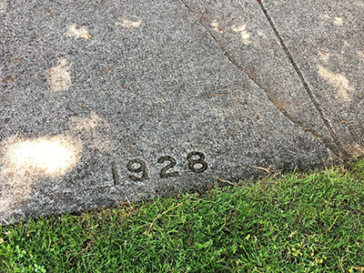 Sidewalk with the year 1928 stamped on it