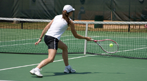 Tennis player rallying a ball in a tennis court