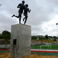 A sculpture of two people running