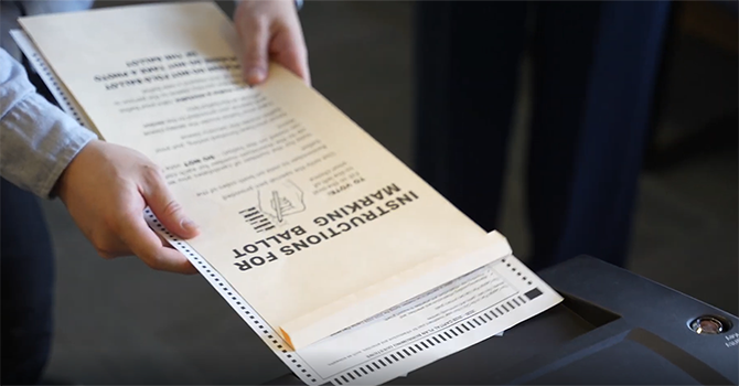 Hands holding voting ballot