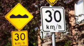 Signs displaying the speed limit of 30kph and a speed bump sign
