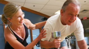 Vancouver community centre personal fitness trainer coaches a senior with equipment Vancouver community centre personal fitness trainer coaches a senior with equipment