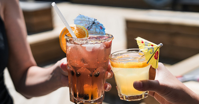 Two raised beverage glasses