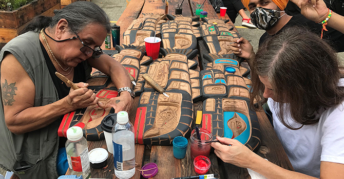 Artist Jimmy Joseph working on a carving