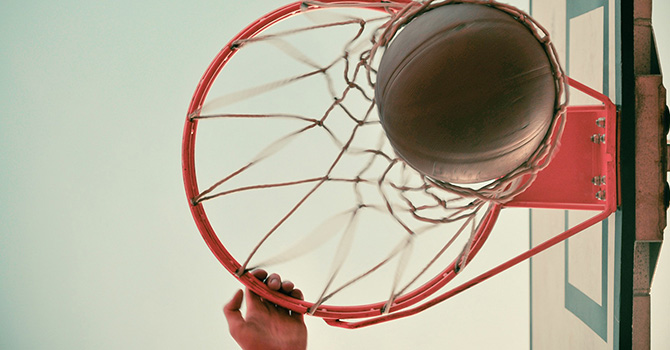 Basketball going through a hoop from a low angle view