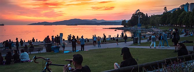 People at beach with sunset in the background