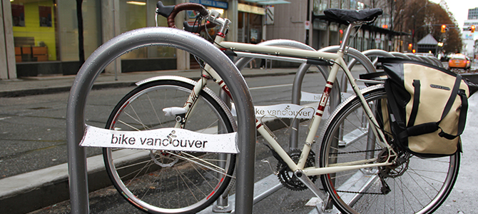 Bike locked to a Bike Vancouver rack on a city street