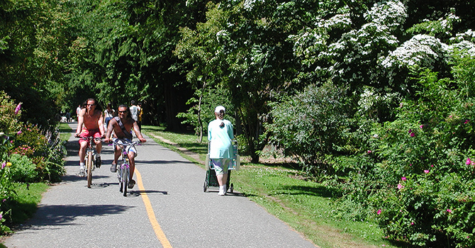 Cyclists and pedestrians enjoying a park pathway.