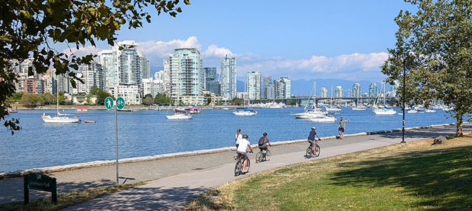 People biking on the seawall on a nice day