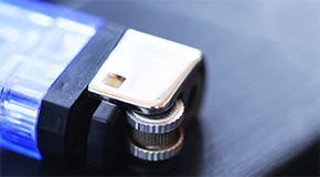 A close up of a blue lighter sitting on a dark table
