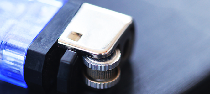 A close up of a blue lighter sitting on a dark table A close up of a blue lighter sitting on a dark table