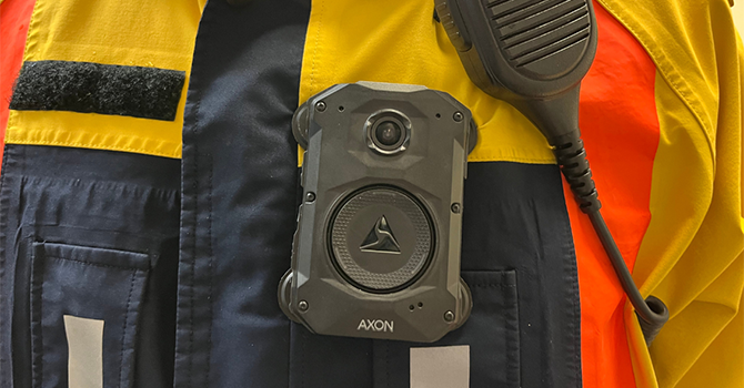 Body-worn camera and radio microphone attached to the uniform of a parking enforcement officer. Body-worn camera and radio microphone attached to the uniform of a parking enforcement officer.