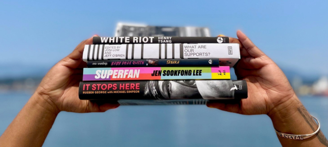 Hands holding a stack of Vancouver Book Award finalists