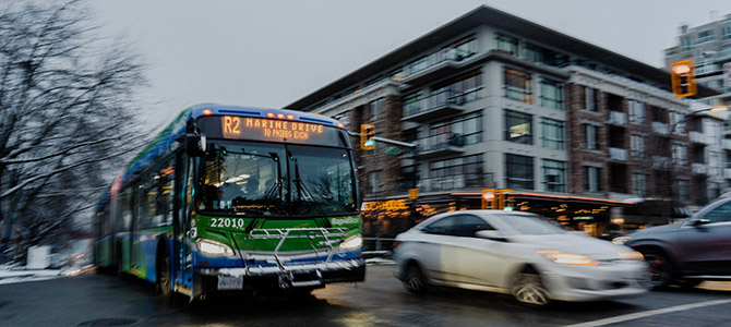 A bus passing a car on a busy street