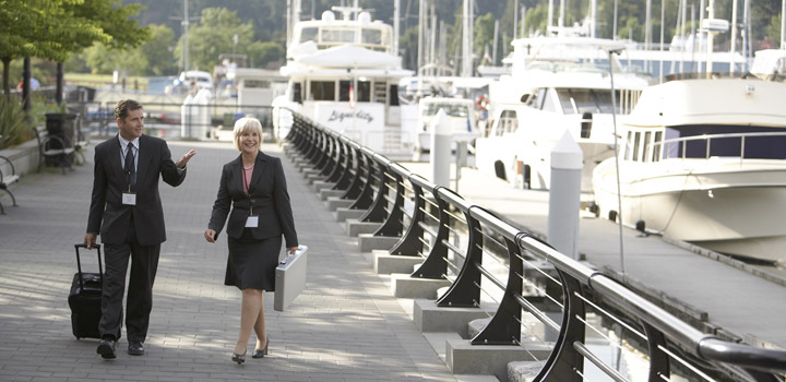 Woman and man in suits walking on the Vancouver seawall