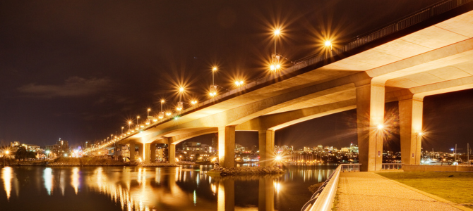 The Cambie Bridge at night with bright street lights