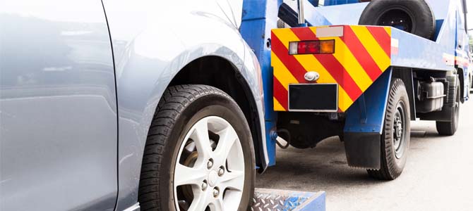 Car being towed by a tow truck