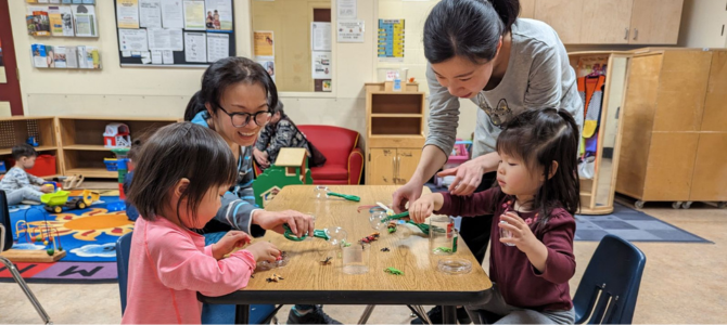 Children around a table doing crafts with care takers