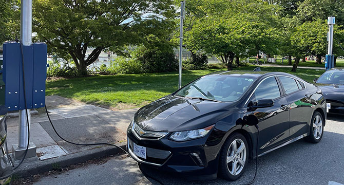 Car on street plugged in to charger