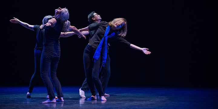 Men and women performing community dance