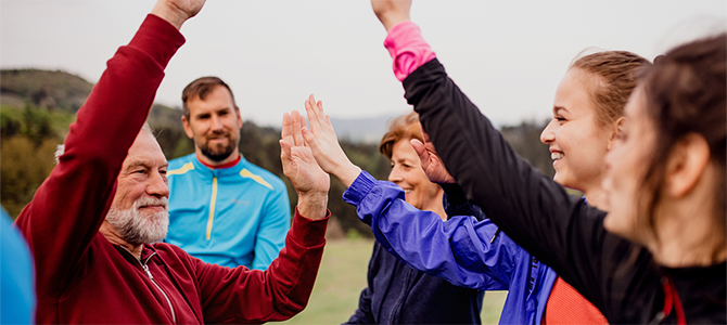 A group of people high-five in celebration