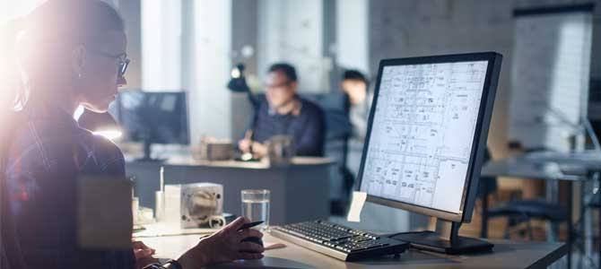 Person at desk looking at computer screen