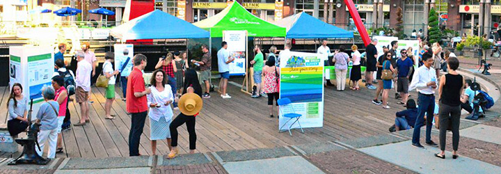 People gathered at a consultation event outdoors at the Roundhouse