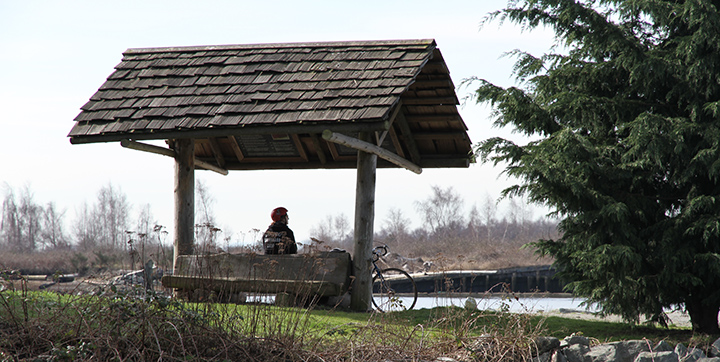 Cyclist resting on a bench