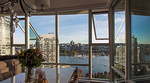 Dining room with a flower centrepiece looking over False Creek harbour, Spruce Harbour Marina, and the Fairview neighbourhood Dining room with a flower centrepiece looking over False Creek harbour, Spruce Harbour Marina, and the Fairview neighbourhood