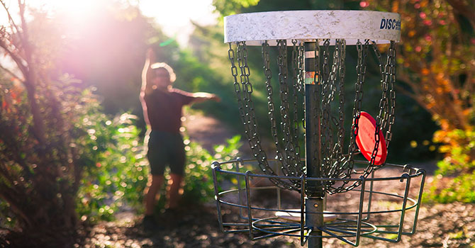 Person playing disc golf Person playing disc golf