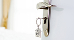 A door handle and key with keychain in the lock A door handle and key with keychain in the lock