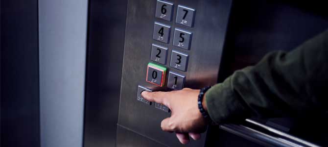 Person's finger pressing elevator button