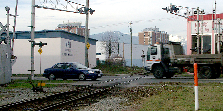 Two vehicles crossing train tracks Two vehicles crossing train tracks
