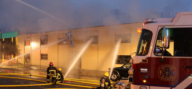 Fire truck in front of a building during a fire