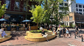 People sitting outside in Gastown on a sunny day