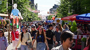Crowds walking through the Granville Street Pedestrian Zone decorated for the FIFA World Cup in downtown Vancouver.