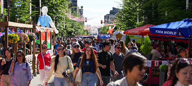 Crowds walking through the Granville Street Pedestrian Zone decorated for the FIFA World Cup in downtown Vancouver.