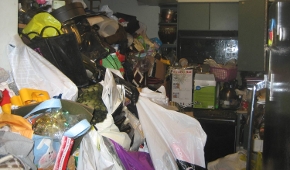 A kitchen with applicances blocked by debris